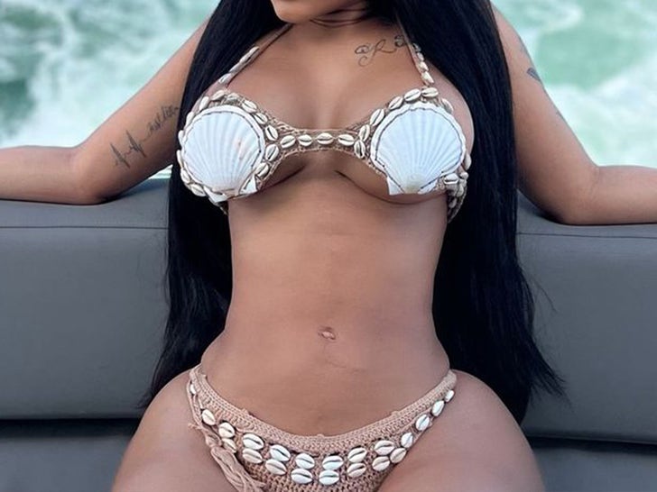 Guess The Babe In The Seashell Swimsuit!