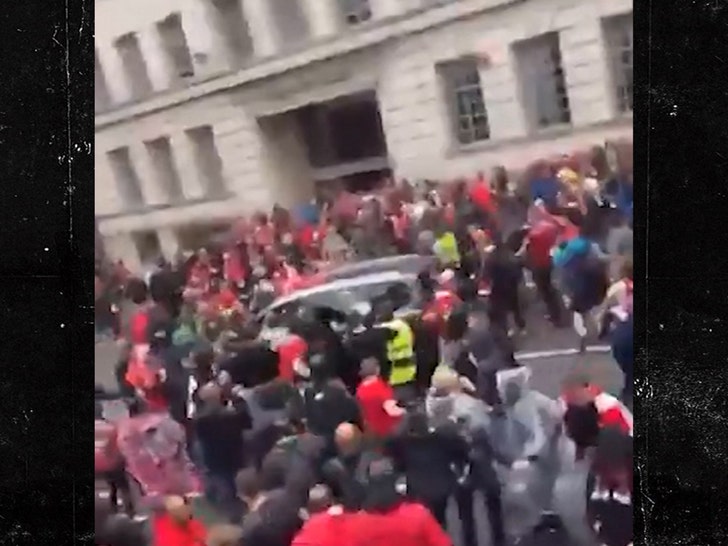 Automotive Plows By way of Large Crowd at Liverpool Soccer Parade in UK, on Video